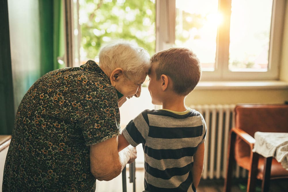 Charter Senior Living Jefferson City a resident standing in doorway with young grandson