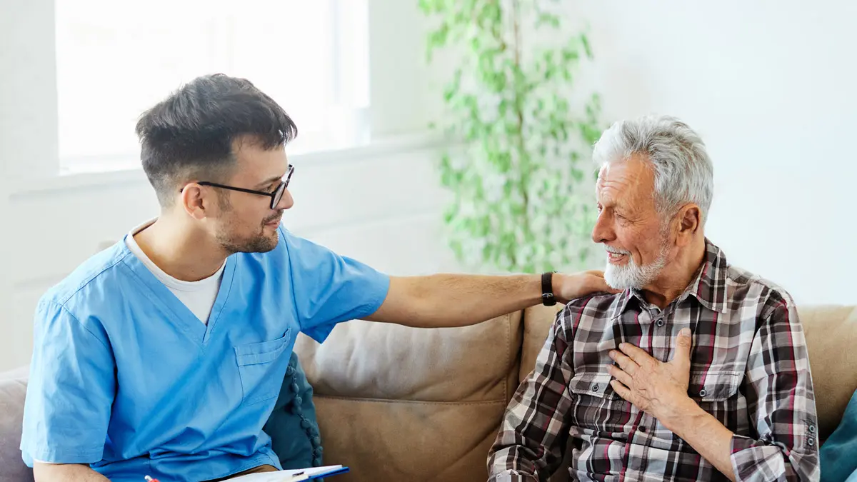 Caregiver speaking compassionately with a resident at Charter Senior Living of Jefferson City, TN.